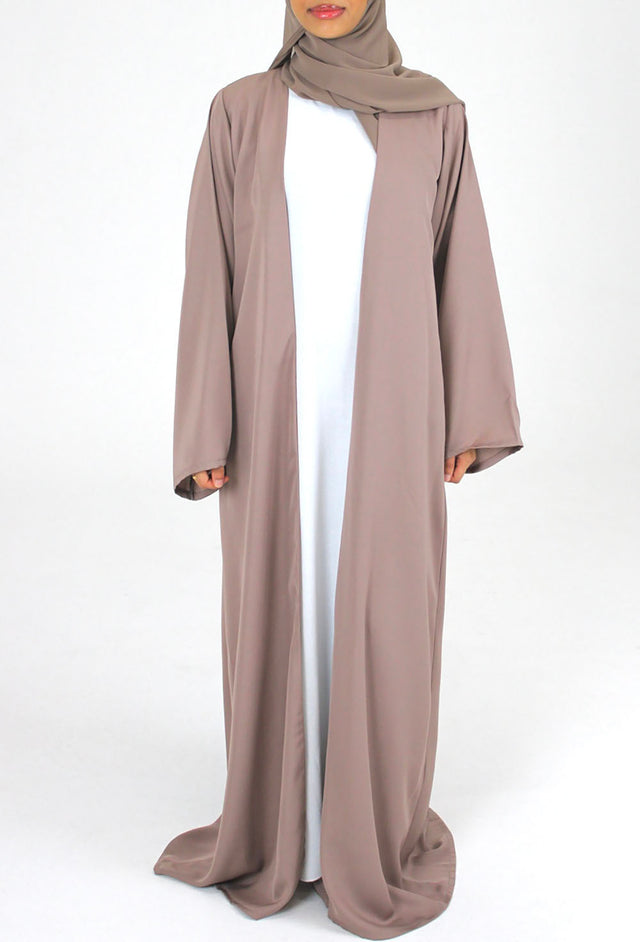 Woman wearing Amani's mocha duster style open abaya with scarf