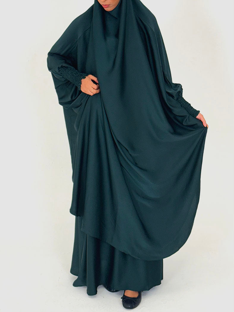 Dark green jilbab set showing jewel-tone satin drape, side view