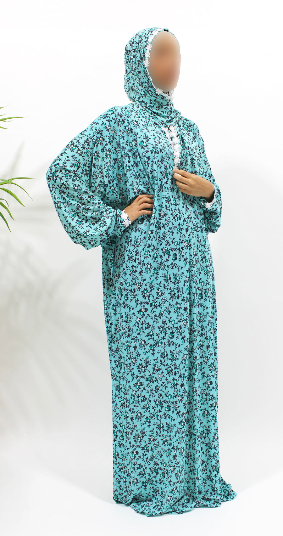 Bright turquoise floral prayer dress showing the lace trim detail