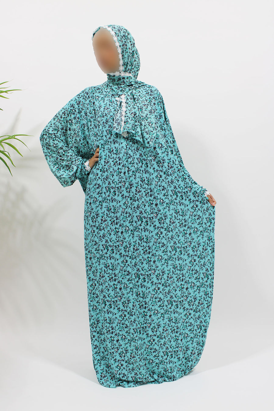 Bright turquoise floral prayer dress showing the attached hijab and full length