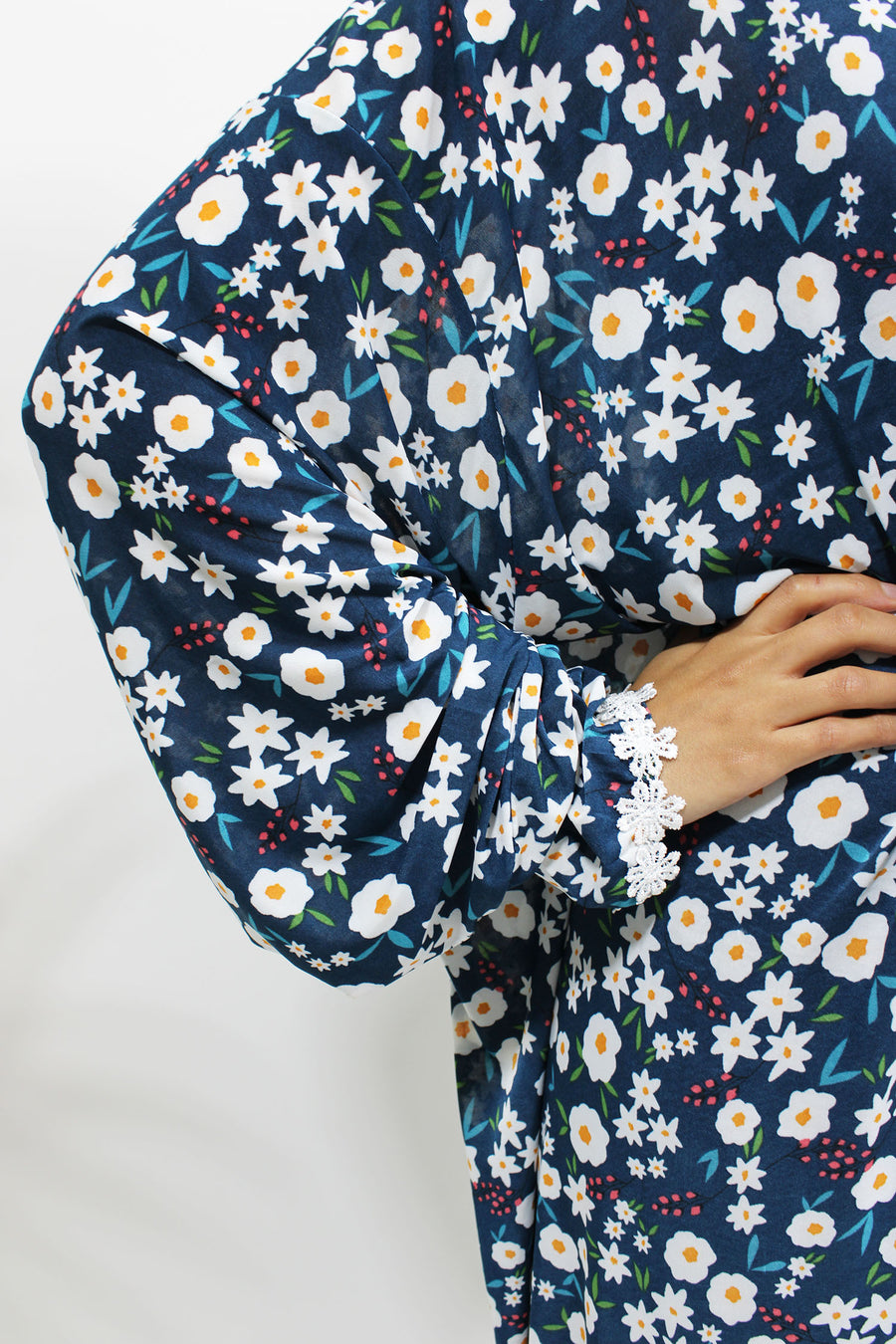 Navy floral prayer dress showing the lace trim detail