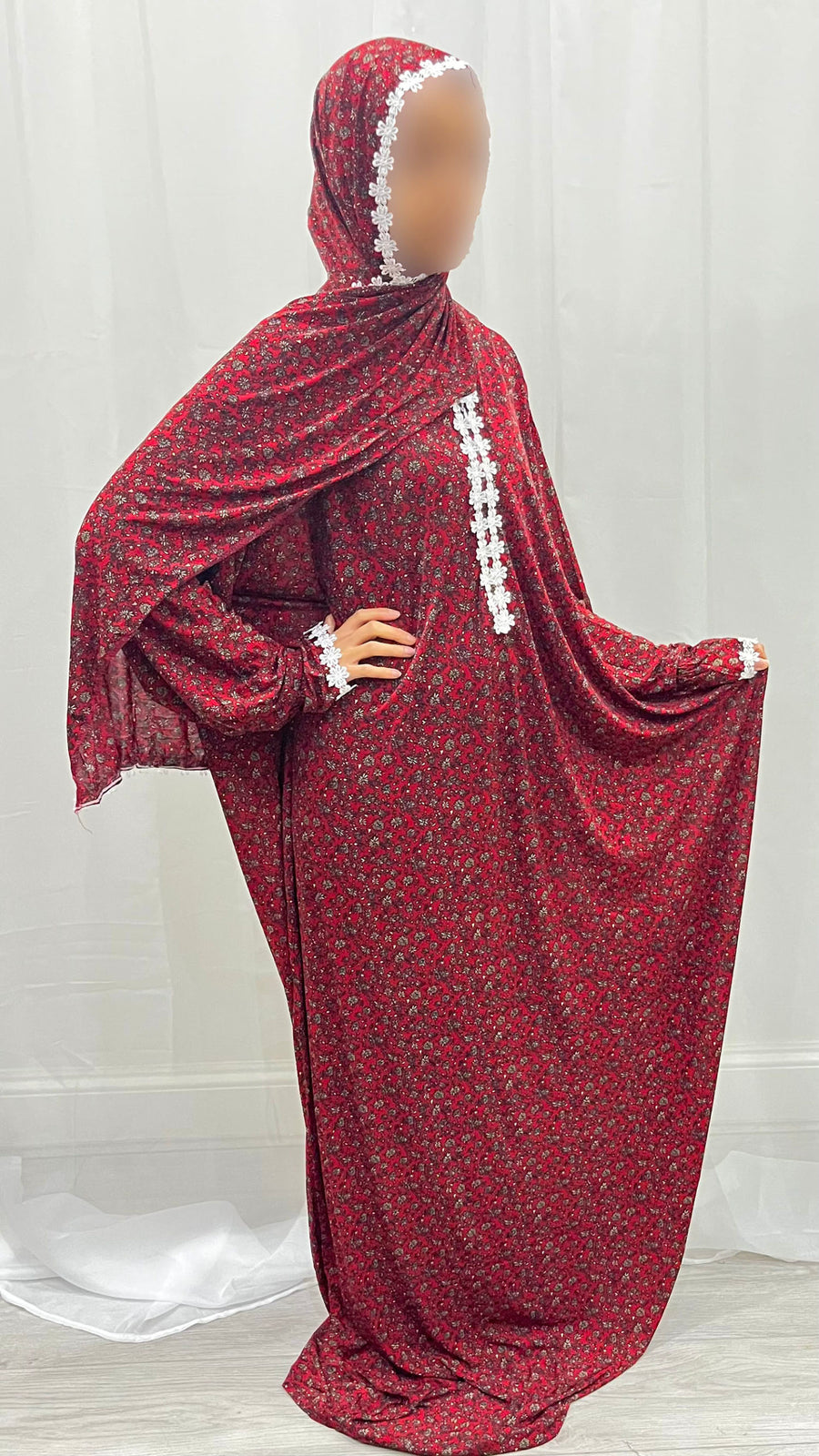 Red floral prayer dress showing the lace trim detail