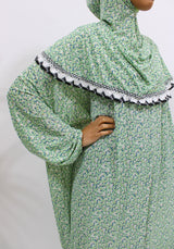 Soft green floral slip-on jersey prayer dress with attached hijab, front view