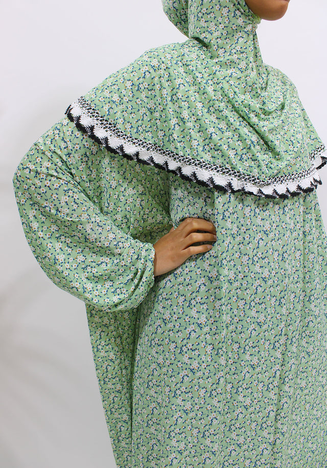 Soft green floral slip-on jersey prayer dress with attached hijab, front view