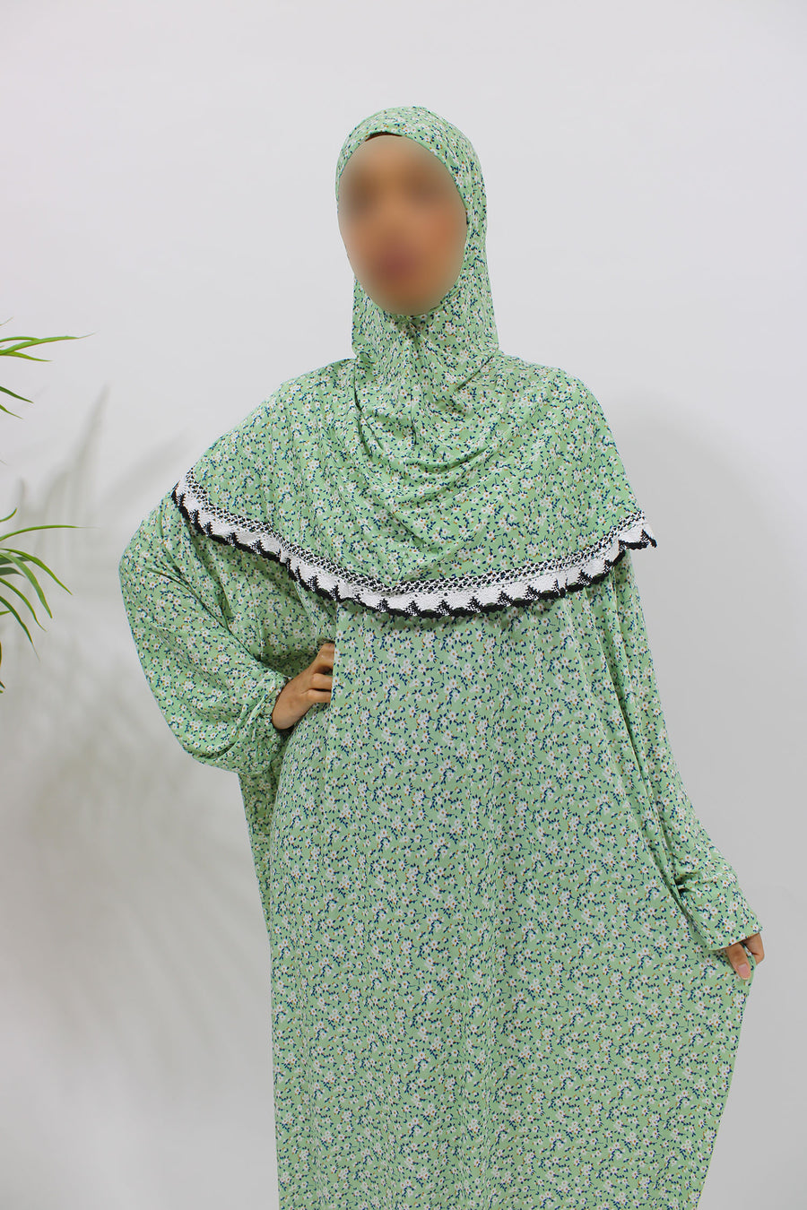 Soft green floral jersey prayer dress showing the attached hijab