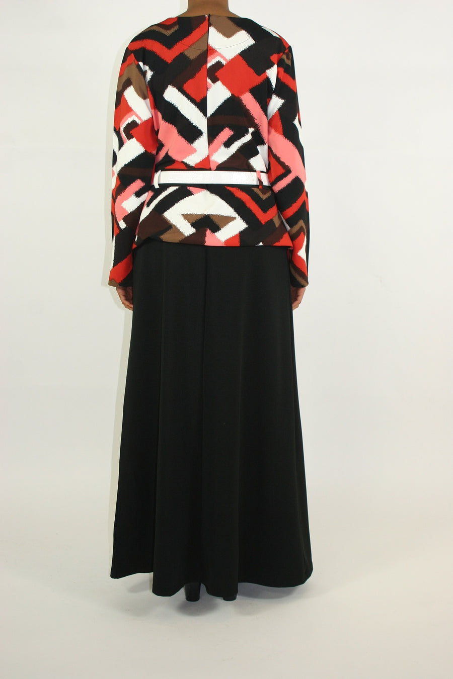 Side view of Amani's orange jacket-layered maxi dress