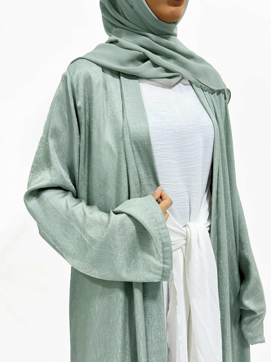 Side view of the sage shimmer open jacket over the white inner dress
