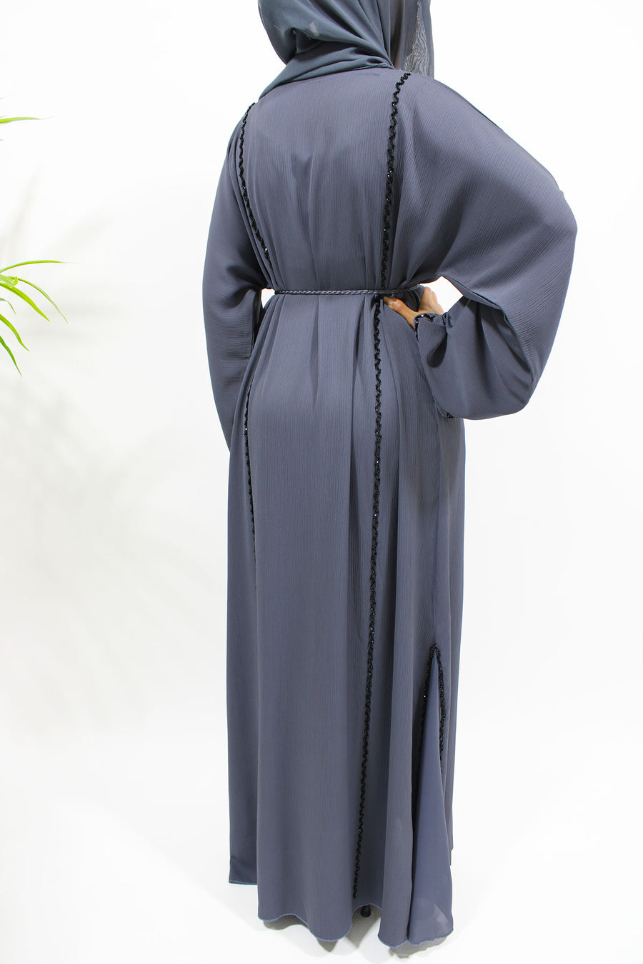 Close view of the hand-stitched black diamante piping on the slate grey abaya