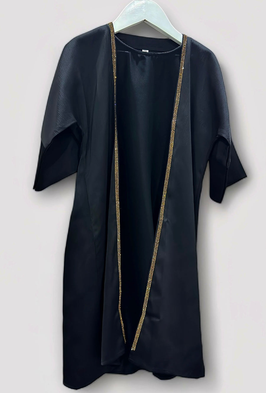 Toddler wearing Amani's black and gold embellished abaya set with hijab