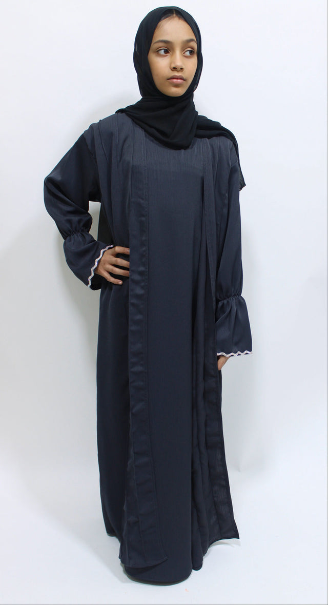 Girl wearing Amani's dark grey two piece style open abaya with scarf