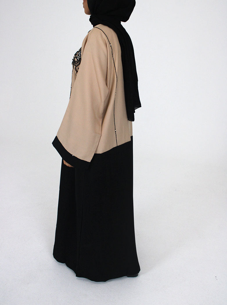 Cream and black abaya jacket layered over an outfit