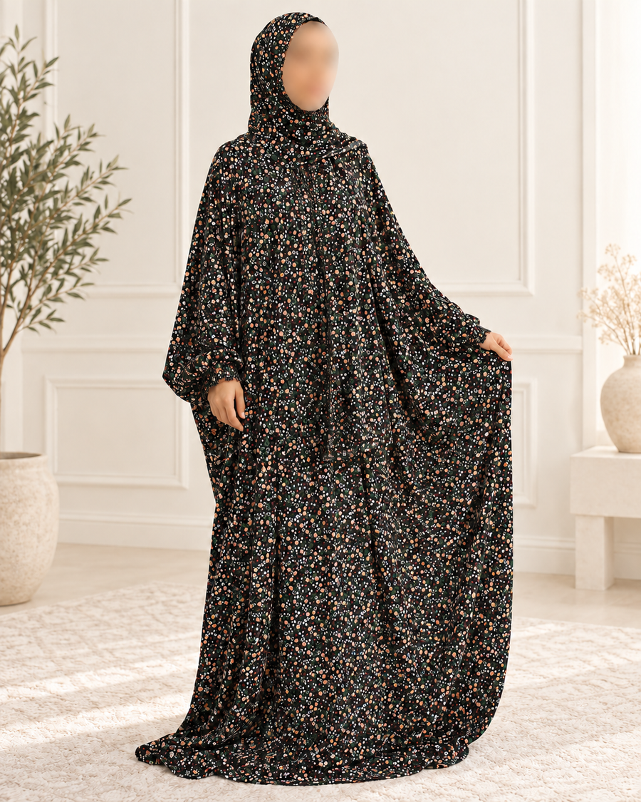 Amani’s black ditsy floral one piece prayer dress with attached hijab, lace-free full-length three-quarter studio view