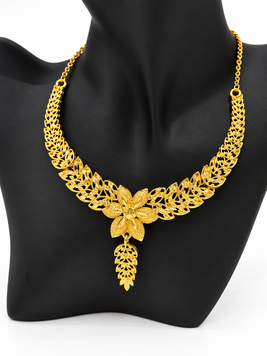 Close view of golden leaf necklace with floral centrepiece