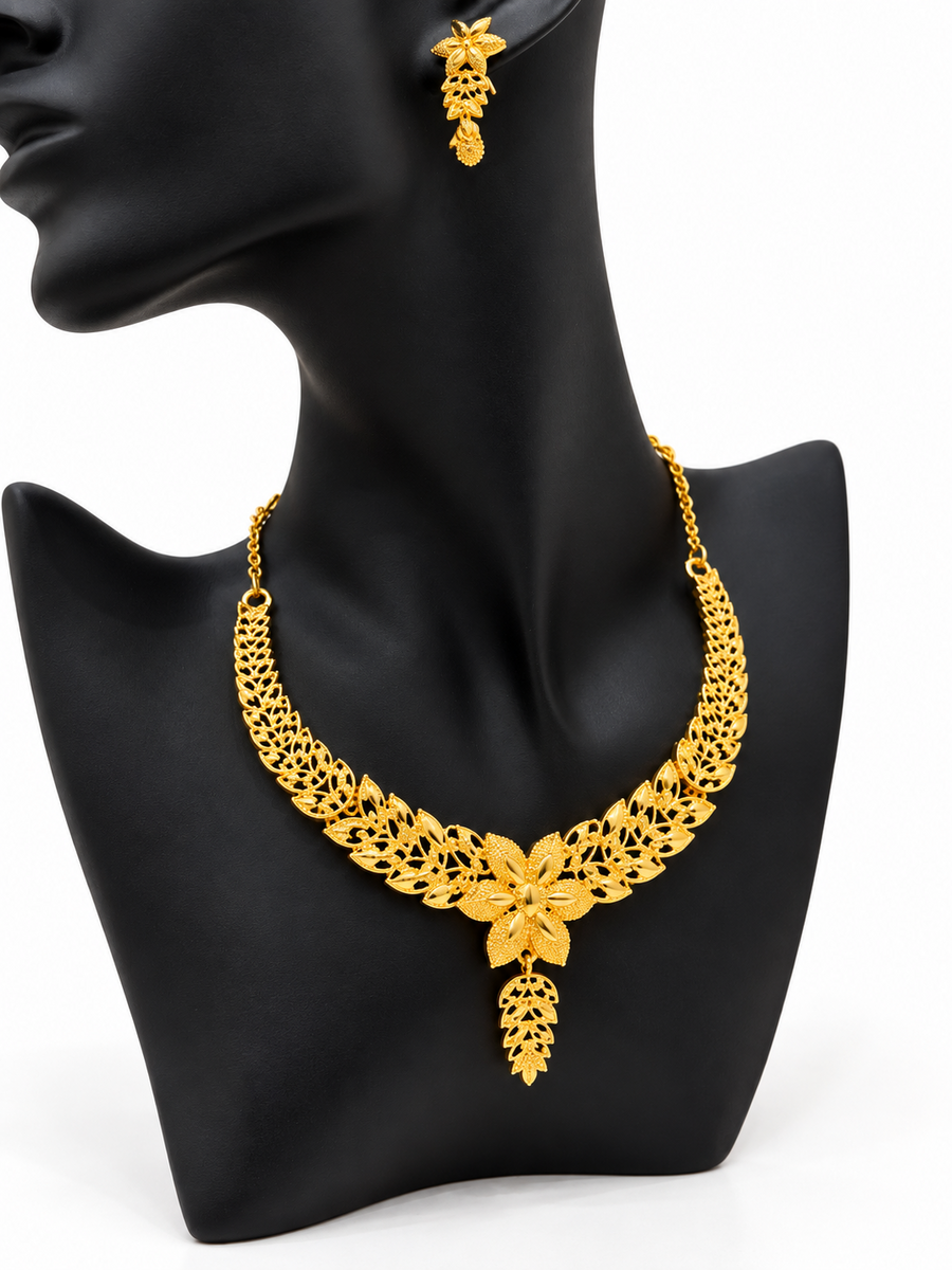 Golden blossom leaf necklace and matching earrings on display