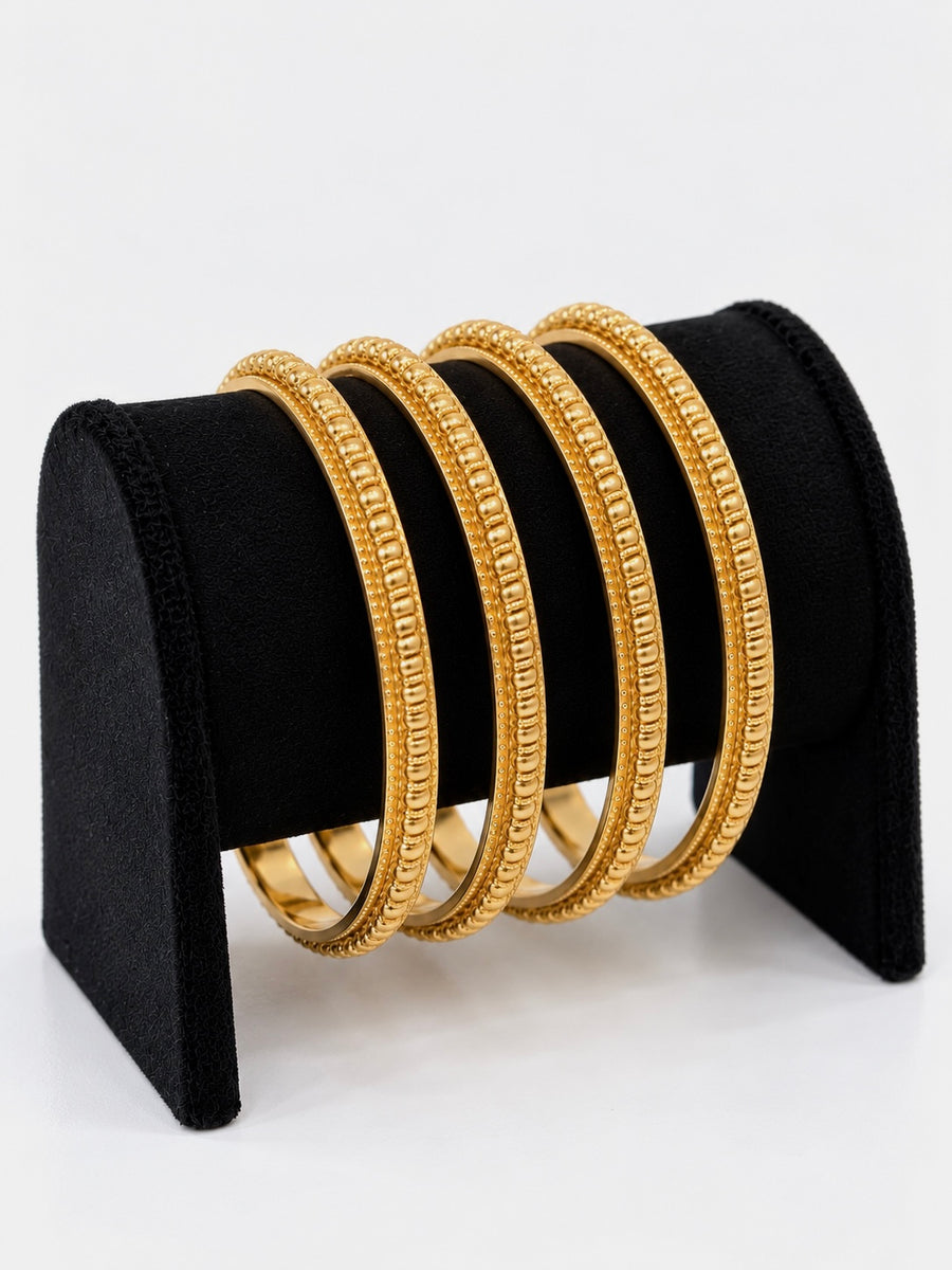Gold beaded-link bangles set of 4 on black jewellery stand