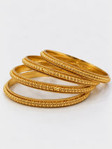 Gold beaded-link bangles set of 4 stacked on white background
