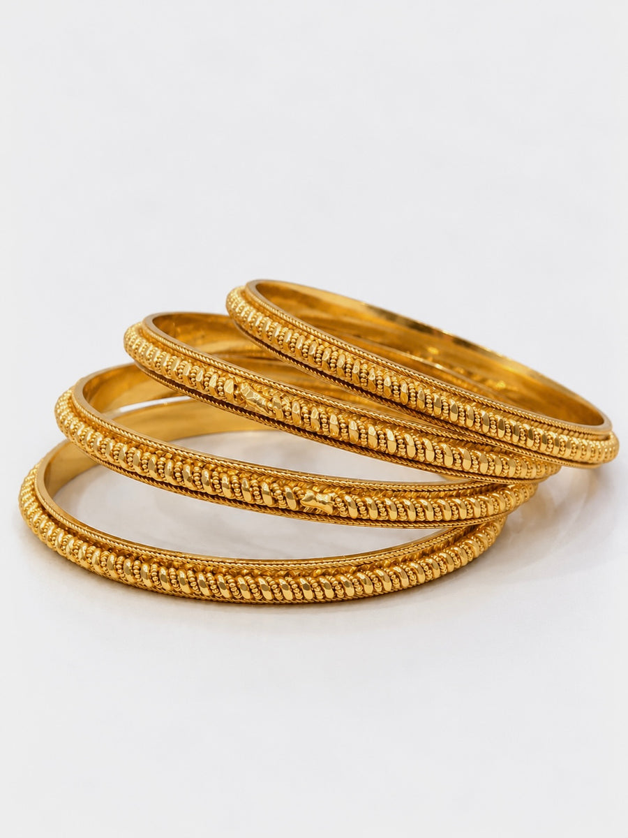 Gold beaded-link bangles set of 4 stacked on white background
