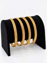 Gold rope-trim textured bangles set of 4 on black jewellery stand