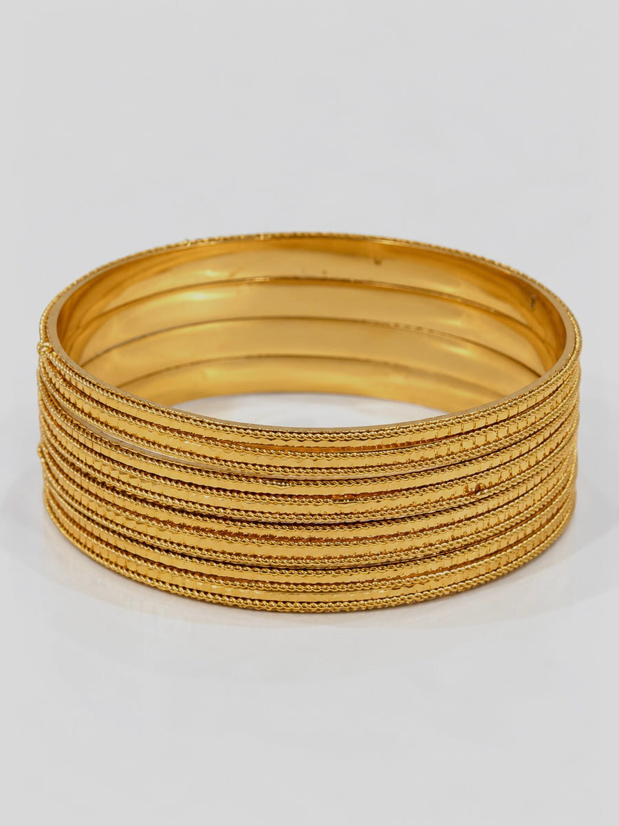 Close-up of four gold rope-trim textured bangles stacked together