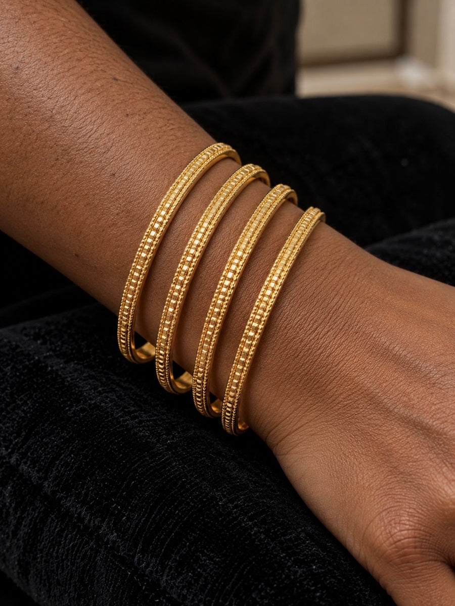 Gold rope-trim textured bangles set of 4 worn on the wrist