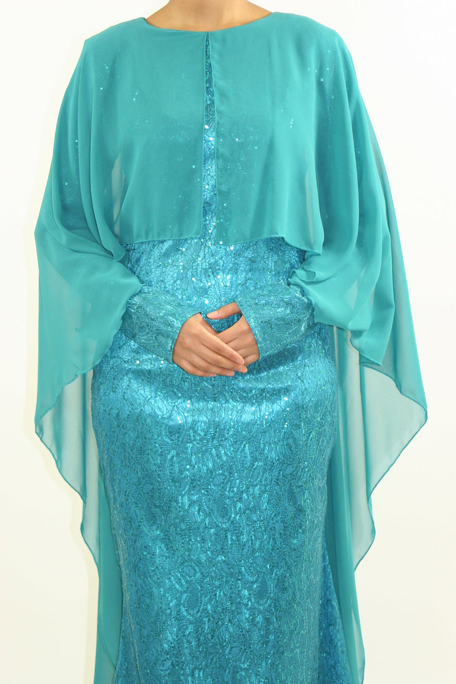 High neckline and long sleeve detail on the occasion caped dress