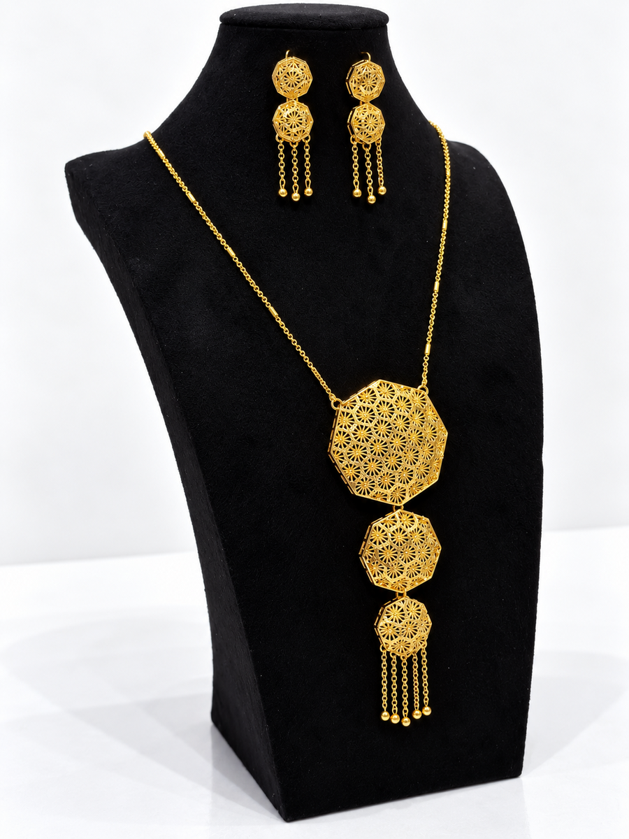 Angled view of gold-tone octagon starburst necklace with matching earrings