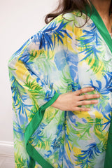 Girl wearing Amani's green palm-print chiffon kids kaftan over an undergarment