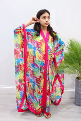 Girl wearing Amani's fuchsia floral chiffon kids kaftan over an undergarment