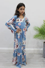 Girl wearing Amani's powder blue floral puff-sleeve tiered dress