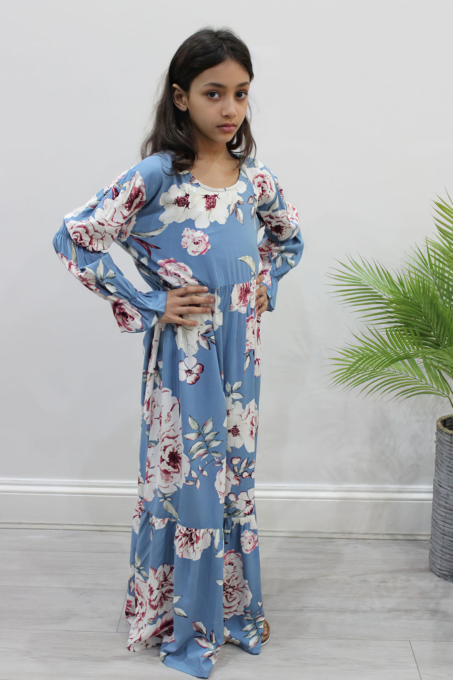 Girl wearing Amani's powder blue floral puff-sleeve tiered dress