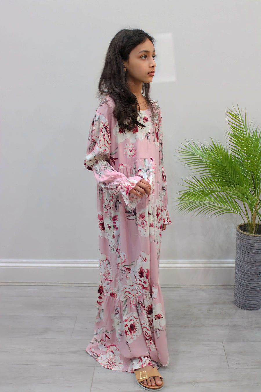 Full-length view of Amani's candy pink puff-sleeve tiered dress