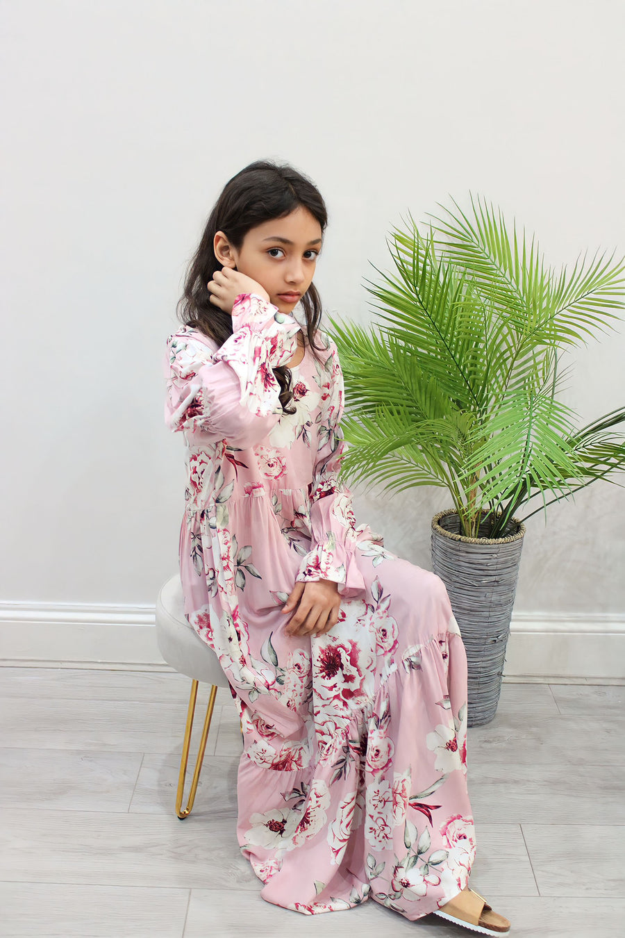 Girl wearing Amani's candy pink floral puff-sleeve tiered dress