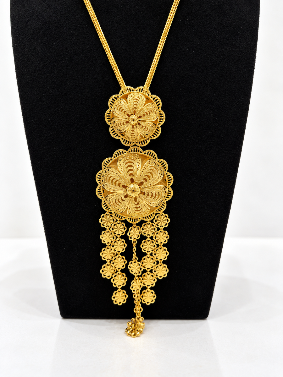 Close-up of gold-tone twin rosette necklace with layered floral drops